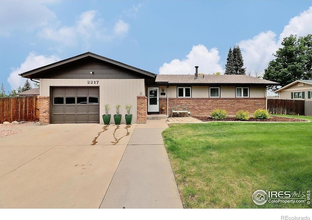 2217 14th St, Greeley, CO 80631 - view of front facade with driveway, brick siding, and an attached garage