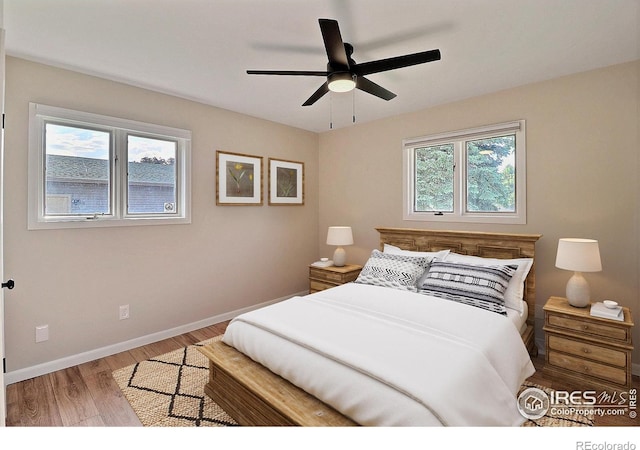 2217 14th St, Greeley, CO 80631 - bedroom with wood finished floors, baseboards, and ceiling fan