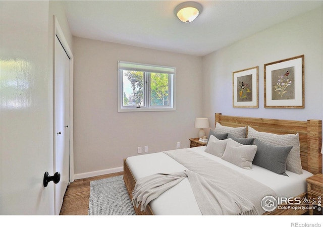 2217 14th St, Greeley, CO 80631 - bedroom featuring wood finished floors, baseboards, and a closet