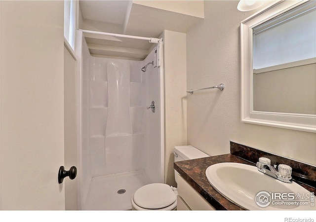 2217 14th St, Greeley, CO 80631 - bathroom featuring vanity, a shower, and toilet