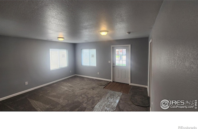 222 Platte St, Sterling, CO 80751 - carpeted foyer with baseboards and a textured ceiling