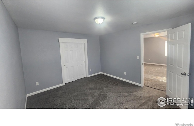 222 Platte St, Sterling, CO 80751 - spare room featuring dark colored carpet, baseboards, and a smoke detector
