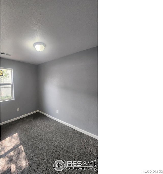 222 Platte St, Sterling, CO 80751 - spare room featuring dark carpet, baseboards, and a textured ceiling