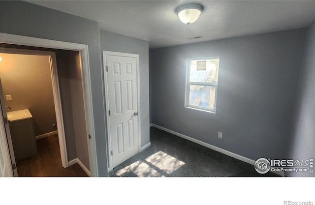 222 Platte St, Sterling, CO 80751 - unfurnished bedroom with baseboards and a textured ceiling