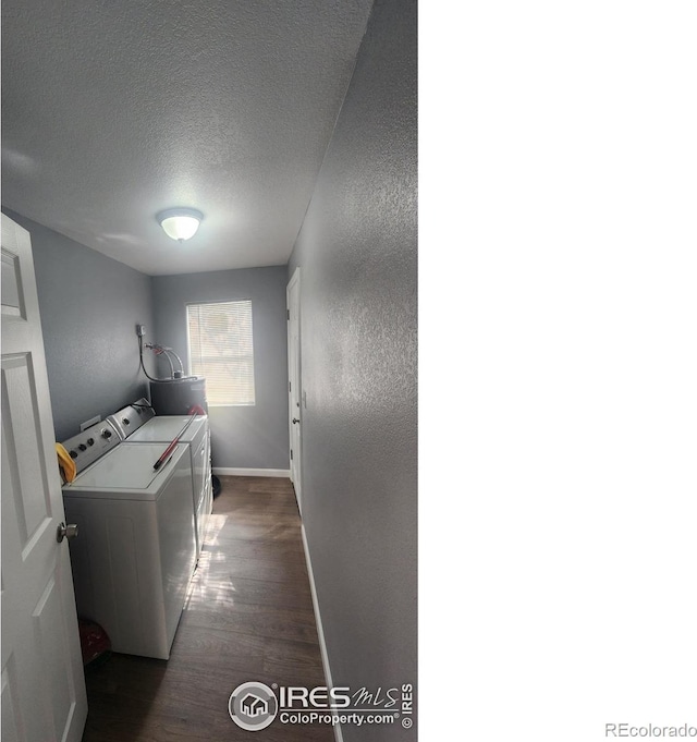 222 Platte St, Sterling, CO 80751 - laundry room with washing machine and dryer, baseboards, wood finished floors, a textured ceiling, and a textured wall