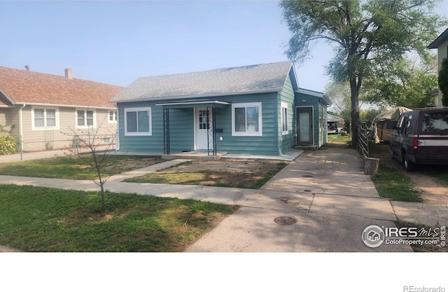 222 Platte St, Sterling, CO 80751 - view of front of house featuring concrete driveway and a shingled roof