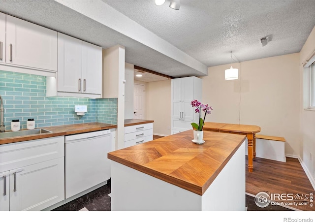 985 W 10th St Unit A5, Loveland, CO 80537 - kitchen featuring wood counters, dishwasher, a sink, white cabinets, and a textured ceiling