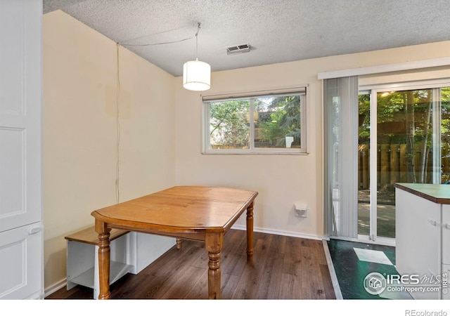 985 W 10th St Unit A5, Loveland, CO 80537 - dining area with wood finished floors, a textured ceiling, and baseboards