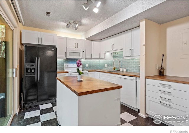 985 W 10th St Unit A5, Loveland, CO 80537 - kitchen with wooden counters, white appliances, a sink, dark flooring, and white cabinetry