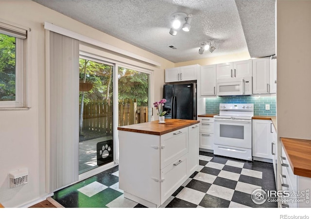 985 W 10th St Unit A5, Loveland, CO 80537 - kitchen with wood counters, white appliances, dark flooring, white cabinets, and backsplash