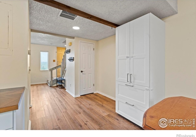 985 W 10th St Unit A5, Loveland, CO 80537 - interior space featuring light wood-style flooring, a textured ceiling, baseboards, recessed lighting, and beam ceiling