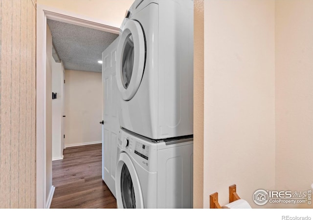 985 W 10th St Unit A5, Loveland, CO 80537 - washroom with stacked washer / drying machine, dark wood-style flooring, and baseboards