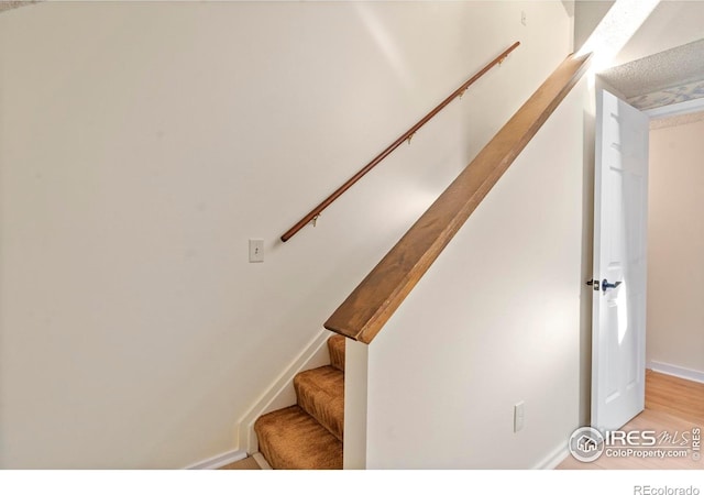 985 W 10th St Unit A5, Loveland, CO 80537 - staircase featuring baseboards and wood finished floors