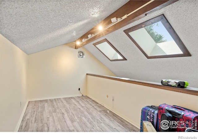 985 W 10th St Unit A5, Loveland, CO 80537 - additional living space featuring wood finished floors, a skylight, a textured ceiling, and baseboards