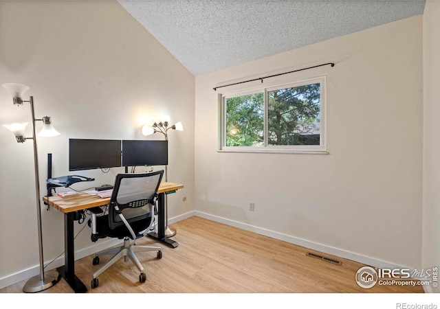 985 W 10th St Unit A5, Loveland, CO 80537 - office area with vaulted ceiling, wood finished floors, baseboards, and a textured ceiling
