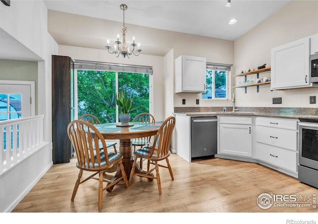 1309 Red Mountain Dr, Longmont, CO 80504 - kitchen featuring appliances with stainless steel finishes, a chandelier, light wood-style floors, white cabinets, and recessed lighting