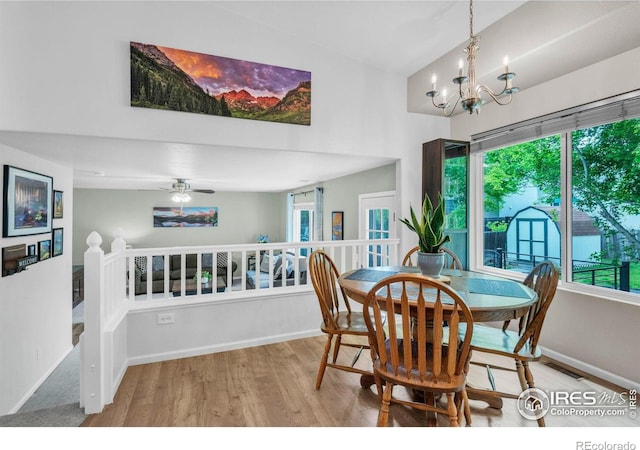 1309 Red Mountain Dr, Longmont, CO 80504 - dining area with wood finished floors, healthy amount of natural light, and a chandelier