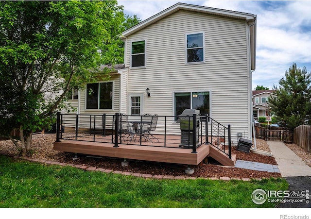 1309 Red Mountain Dr, Longmont, CO 80504 - rear view of house with a deck and outdoor dining area