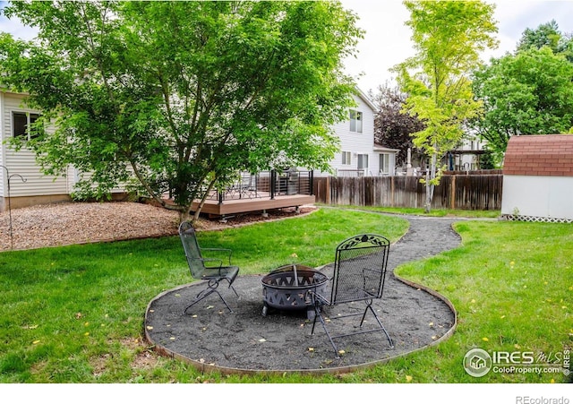 1309 Red Mountain Dr, Longmont, CO 80504 - view of yard with a fire pit, a wooden deck, and a shed