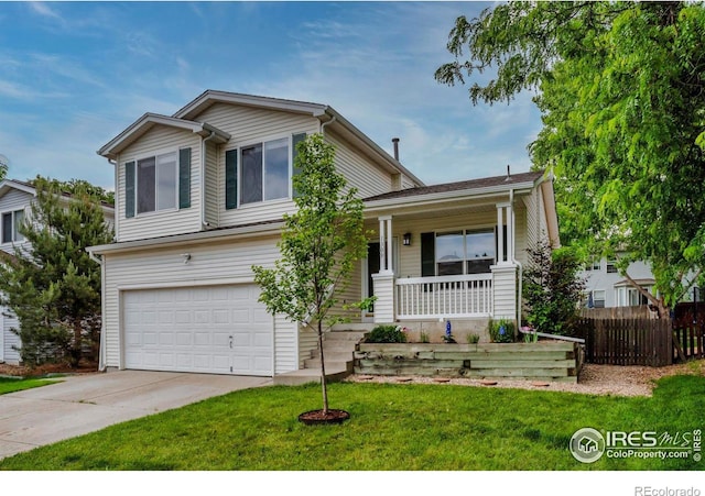 1309 Red Mountain Dr, Longmont, CO 80504 - view of front of property featuring covered porch, a garage, and concrete driveway
