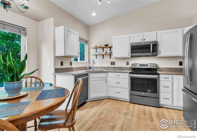 1309 Red Mountain Dr, Longmont, CO 80504 - kitchen with appliances with stainless steel finishes, healthy amount of natural light, white cabinets, and recessed lighting