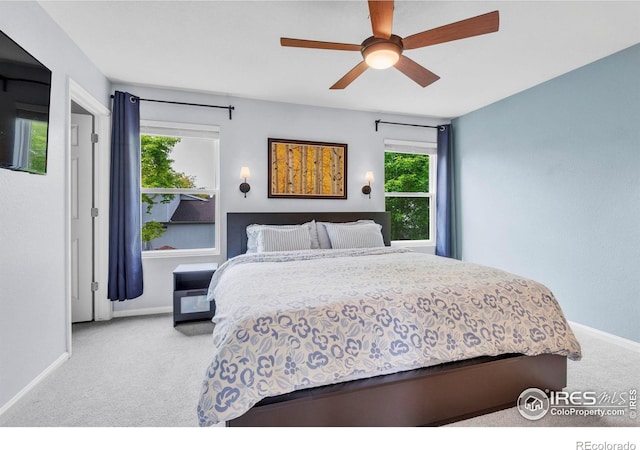 1309 Red Mountain Dr, Longmont, CO 80504 - bedroom featuring carpet flooring, multiple windows, and a ceiling fan