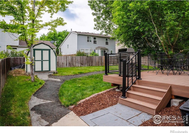 1309 Red Mountain Dr, Longmont, CO 80504 - fenced backyard with a storage unit and a wooden deck