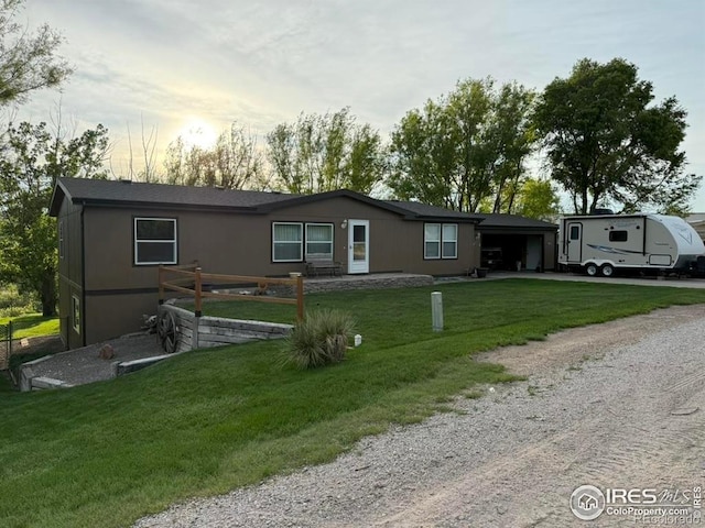 507 Ellis Ave, Wray, CO 80758 - view of front of property featuring driveway, an attached garage, and a front lawn