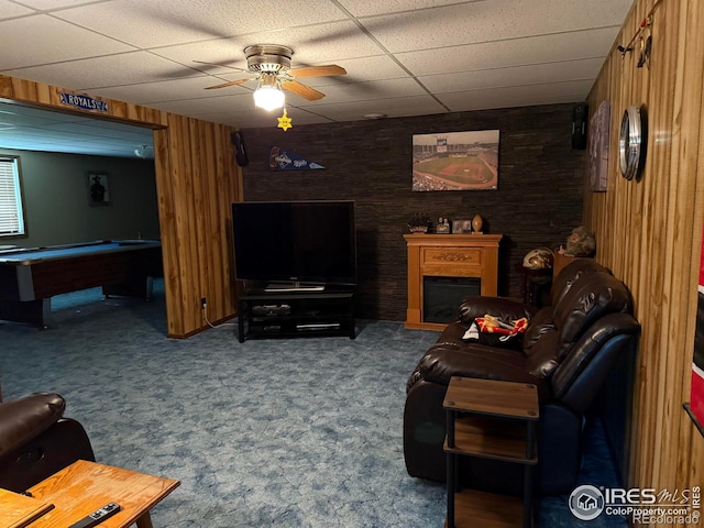 507 Ellis Ave, Wray, CO 80758 - living room with a drop ceiling, a ceiling fan, billiards table, wood walls, and carpet