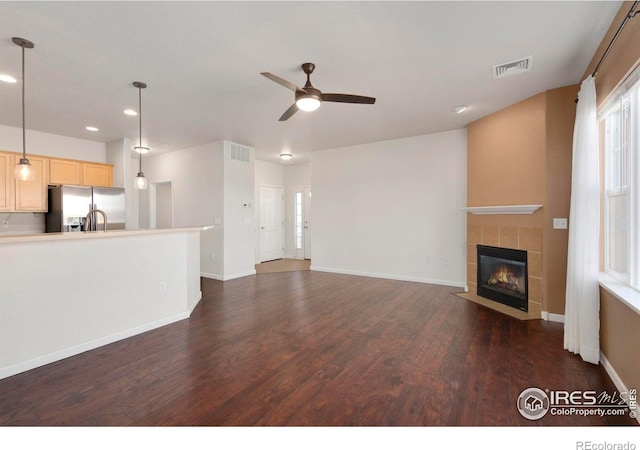 2202 Owens Ave # 102, Fort Collins, CO 80528 - unfurnished living room featuring dark wood-style flooring, ceiling fan, recessed lighting, a fireplace, and baseboards