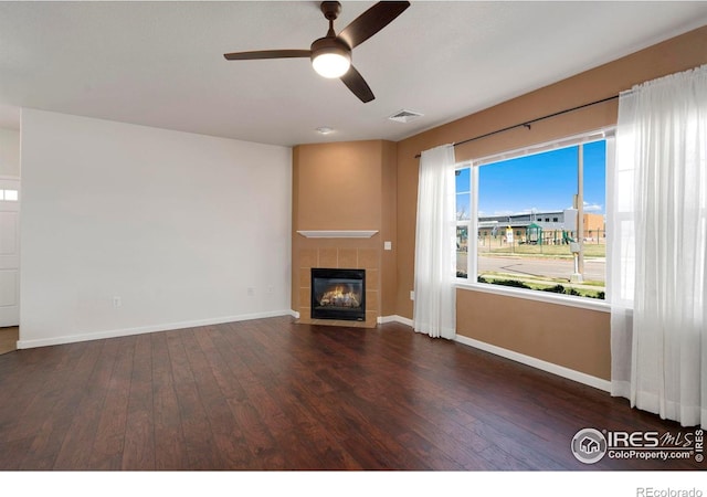 2202 Owens Ave # 102, Fort Collins, CO 80528 - unfurnished living room with hardwood / wood-style floors, ceiling fan, baseboards, and a tiled fireplace