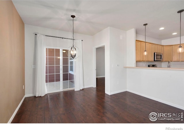 2202 Owens Ave # 102, Fort Collins, CO 80528 - kitchen with stainless steel microwave, wood finished floors, baseboards, light countertops, and recessed lighting