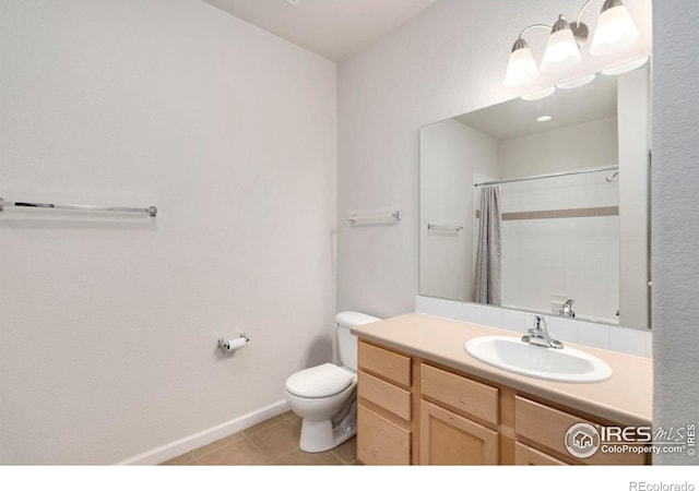 2202 Owens Ave # 102, Fort Collins, CO 80528 - full bathroom with toilet, vanity, tile patterned floors, a shower with shower curtain, and baseboards