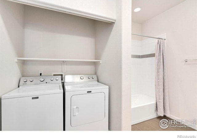 2202 Owens Ave # 102, Fort Collins, CO 80528 - laundry area featuring washing machine and dryer and baseboards