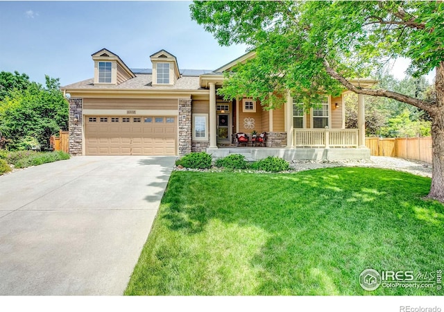 6208 Treestead Ct, Fort Collins, CO 80528 - view of front of house with a porch, stone siding, a garage, and concrete driveway