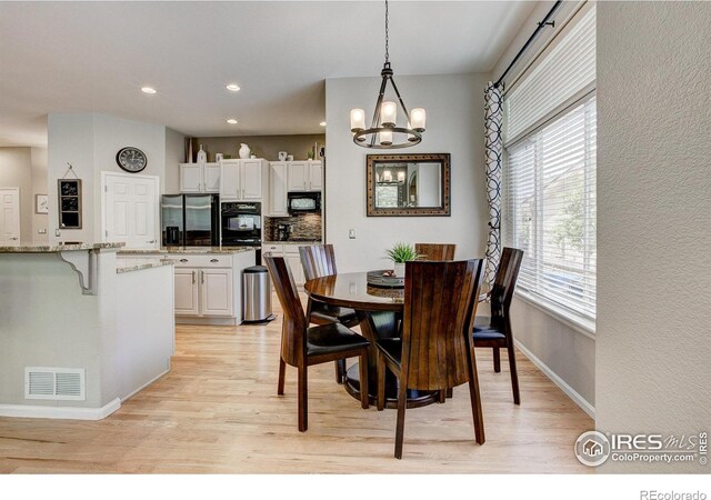 6208 Treestead Ct, Fort Collins, CO 80528 - dining space featuring light wood-style flooring, plenty of natural light, a chandelier, and recessed lighting