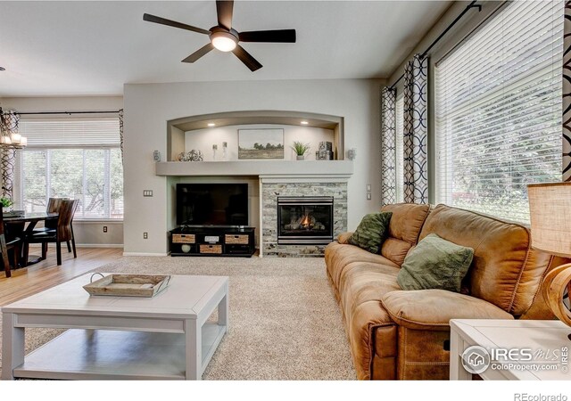 6208 Treestead Ct, Fort Collins, CO 80528 - living room with ceiling fan, a stone fireplace, and baseboards