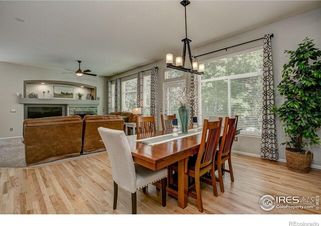 6208 Treestead Ct, Fort Collins, CO 80528 - dining space featuring plenty of natural light, a ceiling fan, and a fireplace