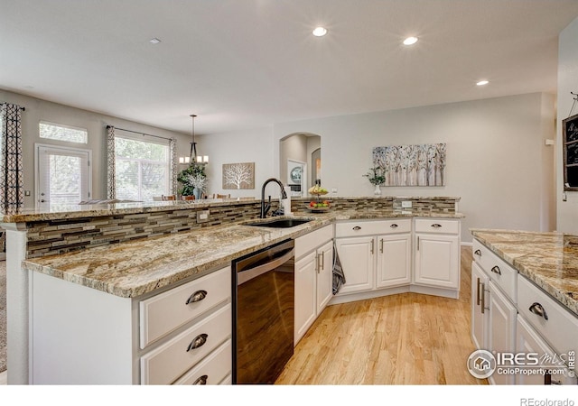 6208 Treestead Ct, Fort Collins, CO 80528 - kitchen featuring dishwashing machine, a sink, arched walkways, light wood-style floors, and recessed lighting