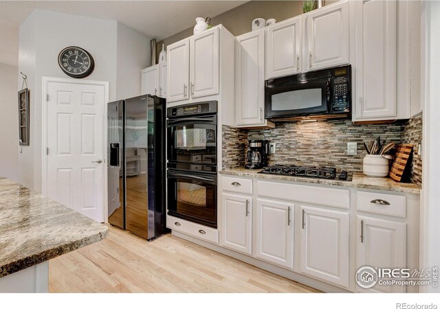 6208 Treestead Ct, Fort Collins, CO 80528 - kitchen featuring black appliances, decorative backsplash, white cabinets, and light wood finished floors