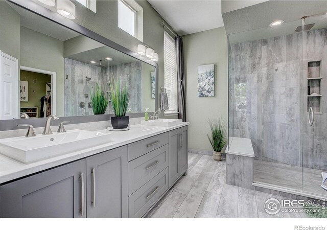 6208 Treestead Ct, Fort Collins, CO 80528 - full bath featuring a stall shower, double vanity, and a walk in closet