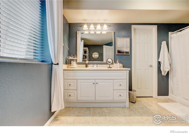 6208 Treestead Ct, Fort Collins, CO 80528 - full bath featuring vanity, baseboards, and a textured wall