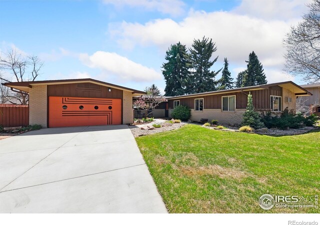 1204 Newsom St, Fort Collins, CO 80524 - mid-century modern home with board and batten siding, brick siding, driveway, and a front lawn