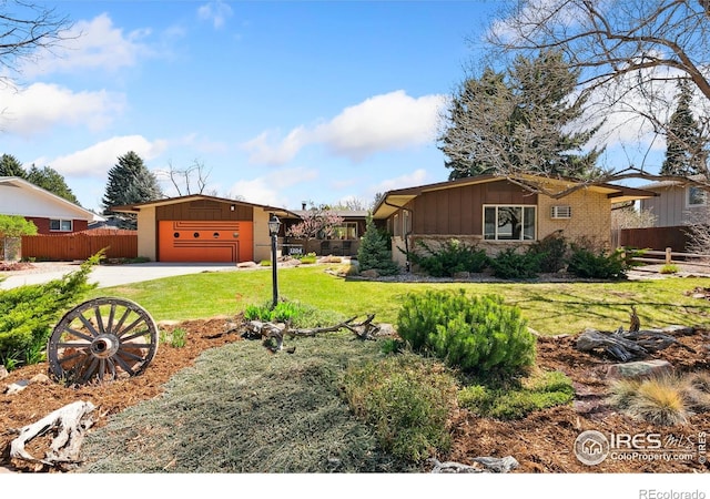 1204 Newsom St, Fort Collins, CO 80524 - view of yard with driveway and a garage