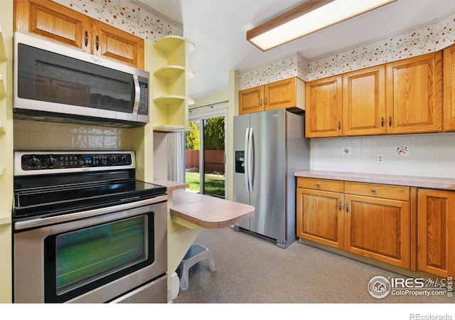 1204 Newsom St, Fort Collins, CO 80524 - kitchen with appliances with stainless steel finishes, backsplash, light countertops, and brown cabinets