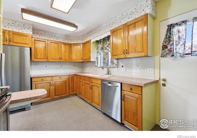 1204 Newsom St, Fort Collins, CO 80524 - kitchen featuring appliances with stainless steel finishes, a sink, light countertops, backsplash, and brown cabinetry