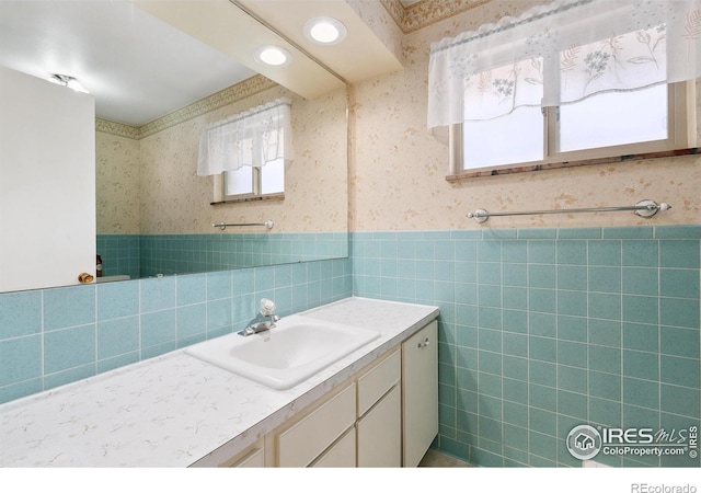 1204 Newsom St, Fort Collins, CO 80524 - bathroom featuring wallpapered walls, vanity, a wainscoted wall, and tile walls
