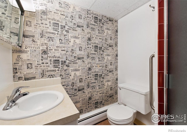 1204 Newsom St, Fort Collins, CO 80524 - full bathroom with a baseboard radiator, toilet, vanity, and an enclosed shower