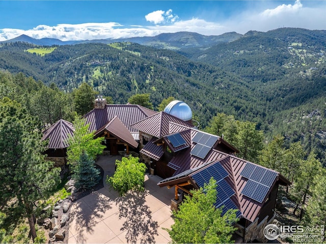409 Wild Horse Cir, Boulder, CO 80304 - aerial view of property and surrounding area featuring a heavily wooded area and a mountainous background