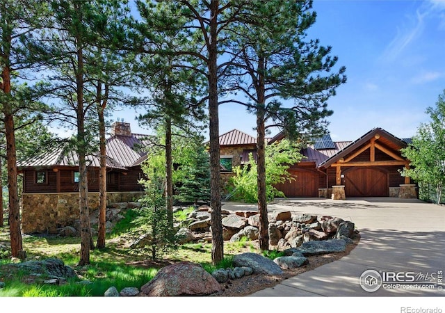409 Wild Horse Cir, Boulder, CO 80304 - view of yard with an attached garage and concrete driveway